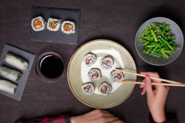 Japon suşi ve siyah bir zemin üzerine yeşil fasulye