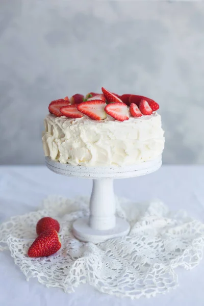 White cream cake with strawberry on the white table