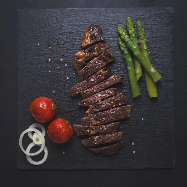 Grilled beef steak on a black background — Stock Photo, Image
