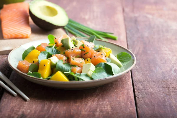 Salada Hawaiian Poke com salmão, abacate e legumes em um fundo rústico — Fotografia de Stock