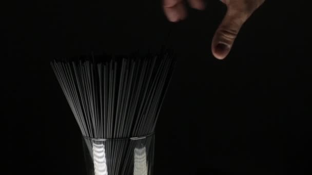 Man touches cuttlefish ink spaghetti pasta on the dark black background — 비디오