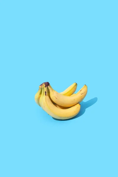 Pilha de bananas no fundo azul com espaço de cópia — Fotografia de Stock