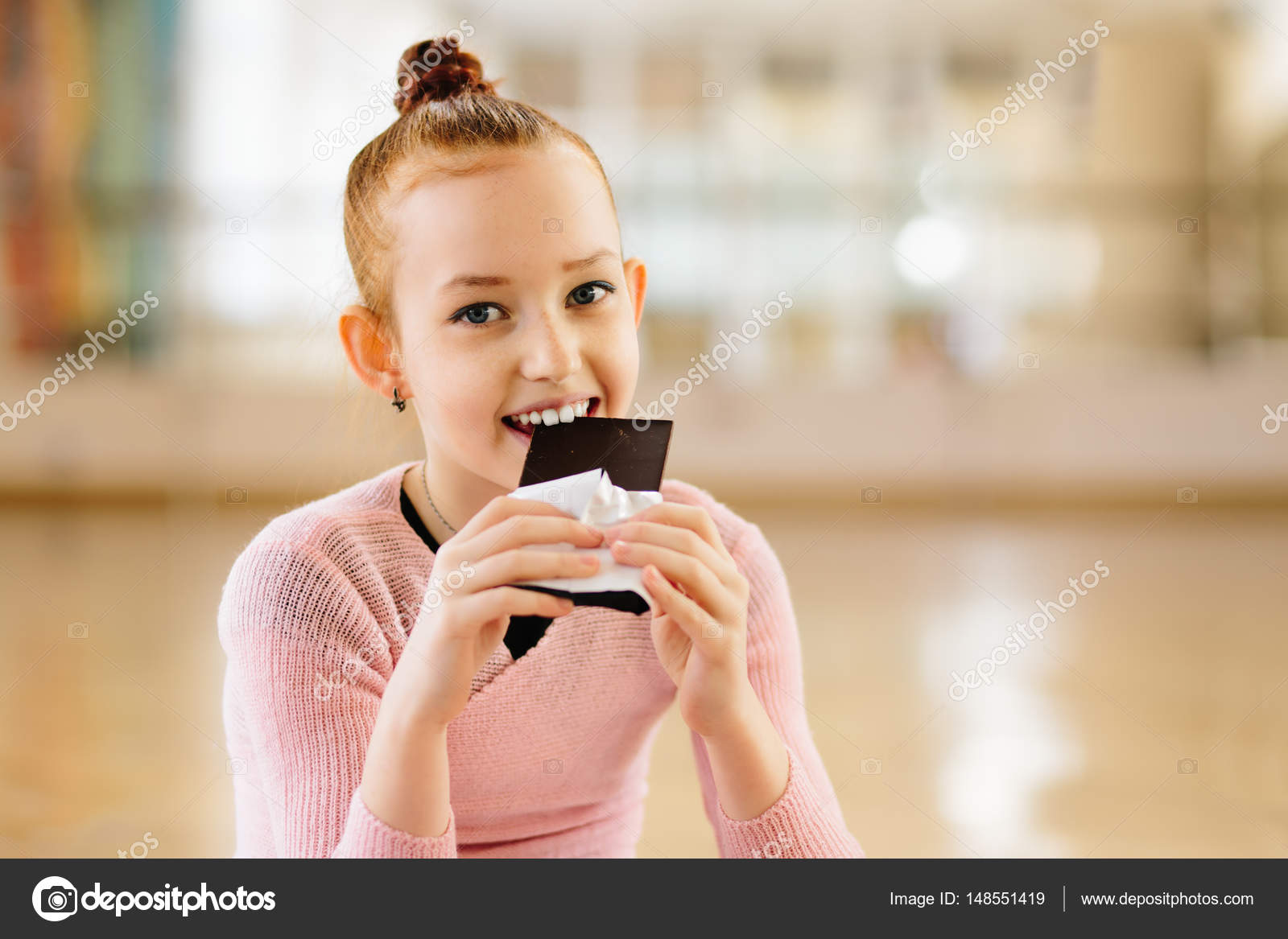 Girl ballerina eating chocolate in ballet class Stock Photo by ©rusvideo  148551419