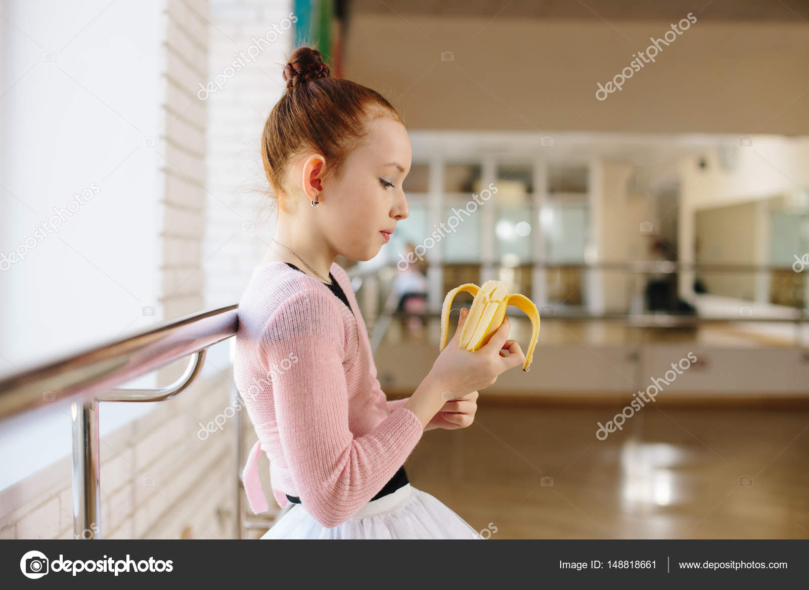 Girl ballerina eating a banana in ballet class Stock Photo by ©rusvideo  148818661