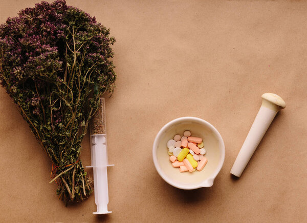 Medicinal herbs and tablets on the table
