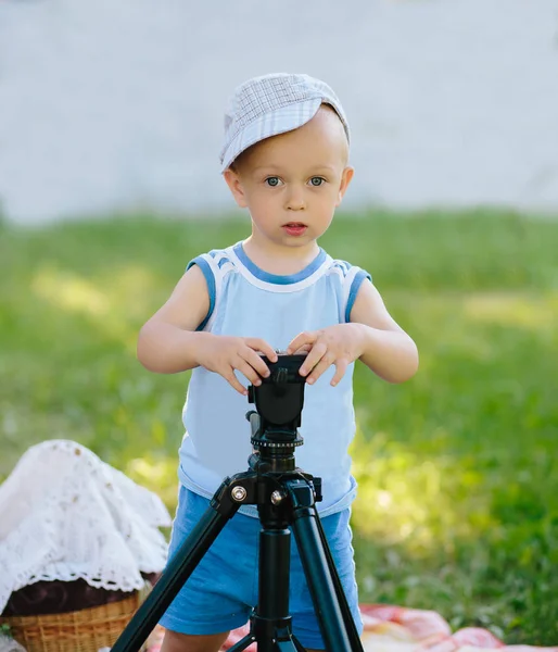 Serious boy works with a tripod — Stock Photo, Image