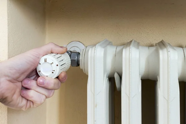 Loodgieter op het werk een thermostatische afsluiter te installeren op een radiator — Stockfoto