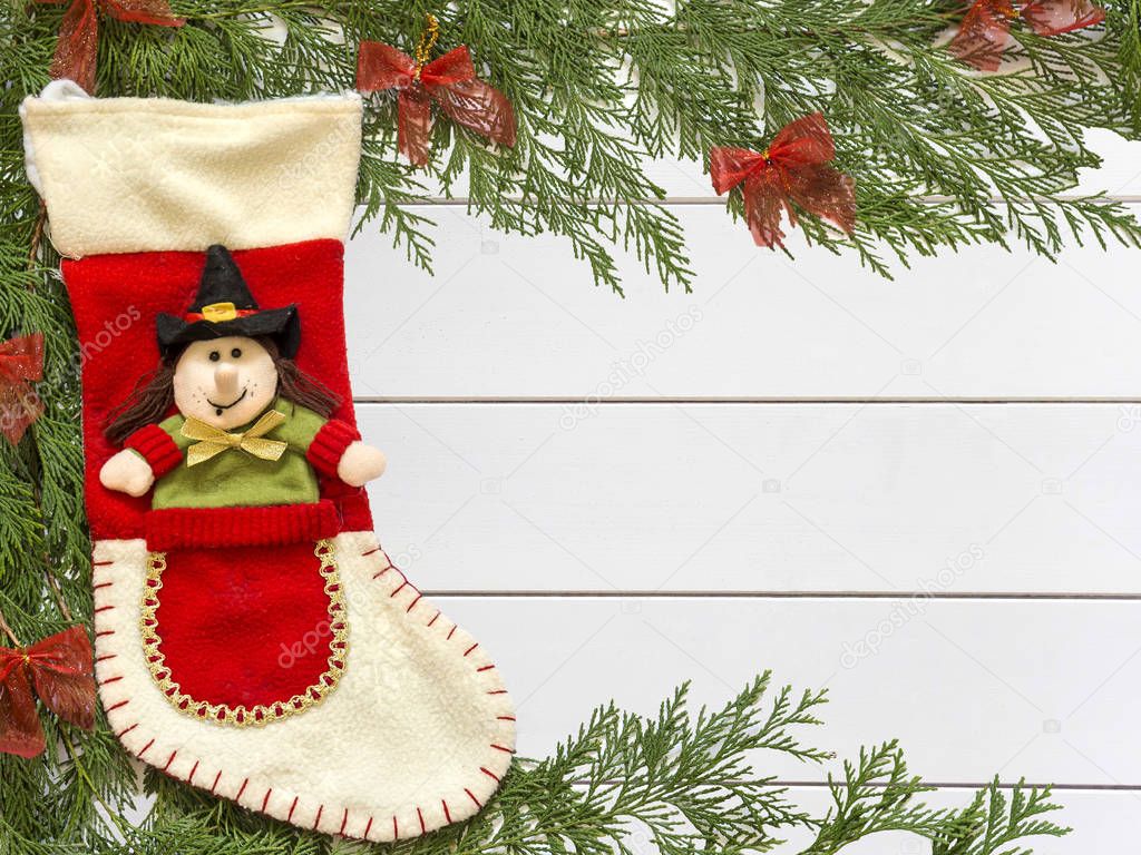 Stocking Befana and Christmas decorations on wooden white background