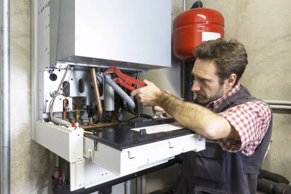 Plumber Repairing Condensing Boiler — Stock Photo, Image