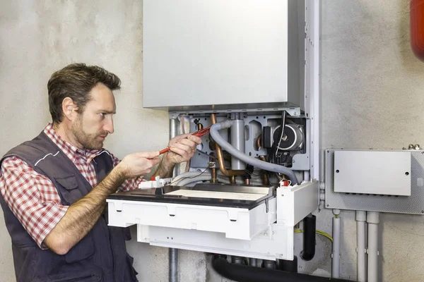 Plumber Repairing Condensing Boiler — Stock Photo, Image