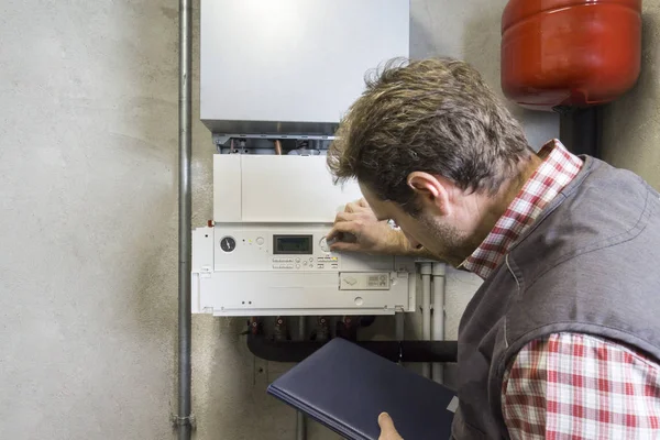 Plumber Repairing Condensing Boiler — Stock Photo, Image