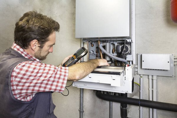 plumber repairing a condensing boiler