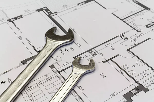 Maintenance and service: Wrench and project drawings with residential building