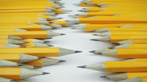 Yellow pencils randomly lie on a white background — Stock Video