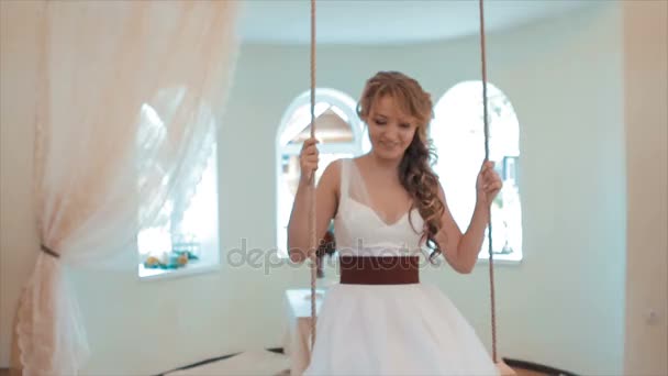 Bride Swinging on a Swing in the Room — Stock Video