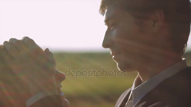 Close up Groom Tenderly Touches Face of Bride at Sunset — Stock Video