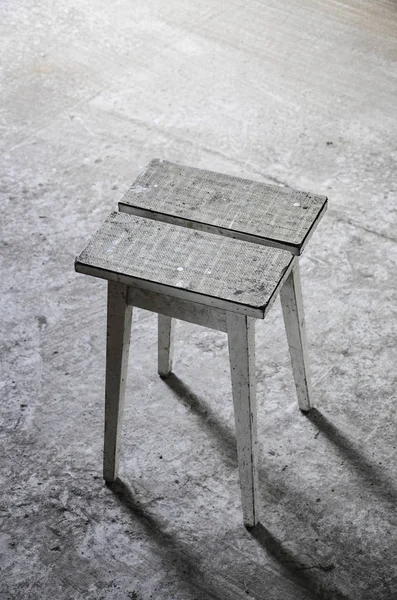 Abandoned place with wooden stool — Stock Photo, Image