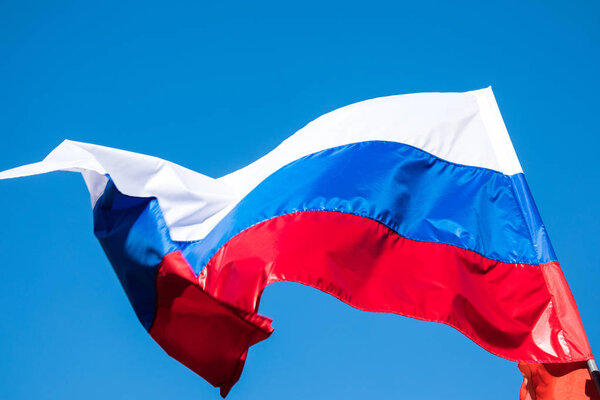 The government flag of Russian Federation or Russia on the sky background.