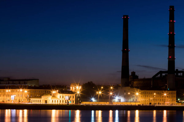The evening thermal power station on the Neva river embankment in Saint Petersburg, Russia
