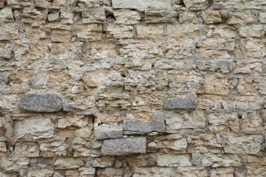 Kahverengi ve gri kaldırım taşı veya tuğla kule, kale veya kale duvarı arka planı veya dokusu