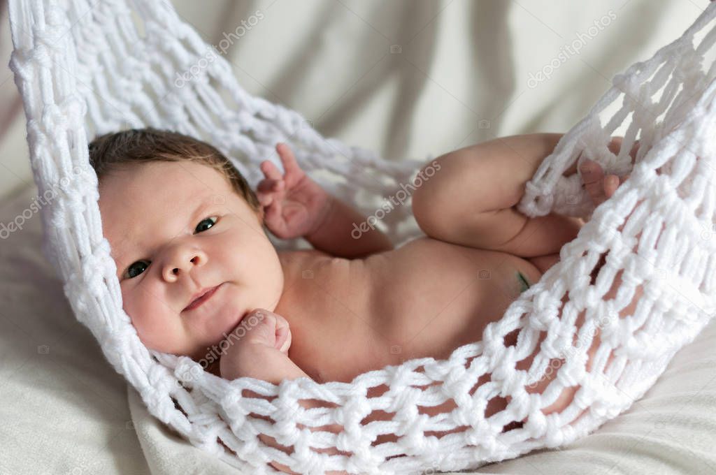 Newborn baby boy  wrapped in the blanket knitted