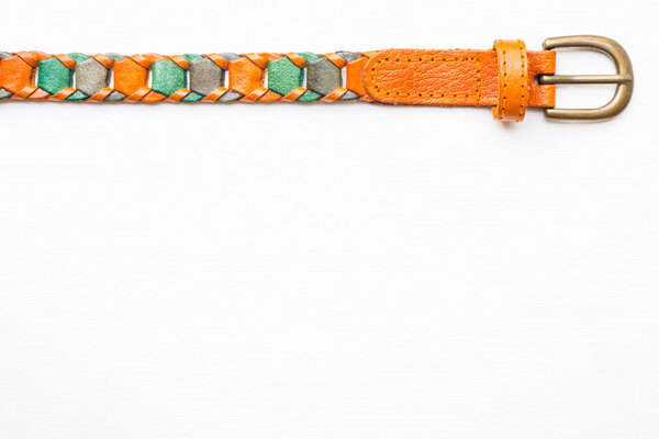 Leather knitted belt on white canvas background