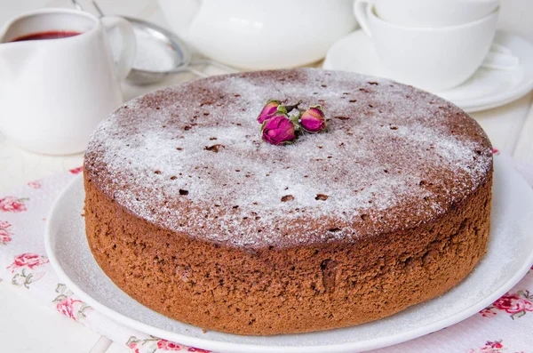 Chocolate sponge cake covered with powdered sugar