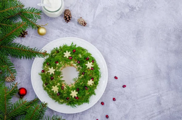 Olivier salatası Noel çelengi, sebze, et, yumurta ve mayonez ile gri bir arka planda. Geleneksel Rus ve Ukrayna salatası Noel ve Yeni Yıl için. Boşluğu kopyala.