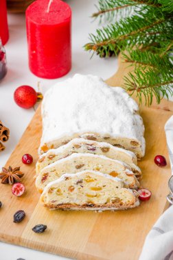 Kurutulmuş meyve, fındık ve krema ile süslenmiş Noel süslemesi. Geleneksel Alman Noel meyveli keki. Kapatın. Dikey yönelim.