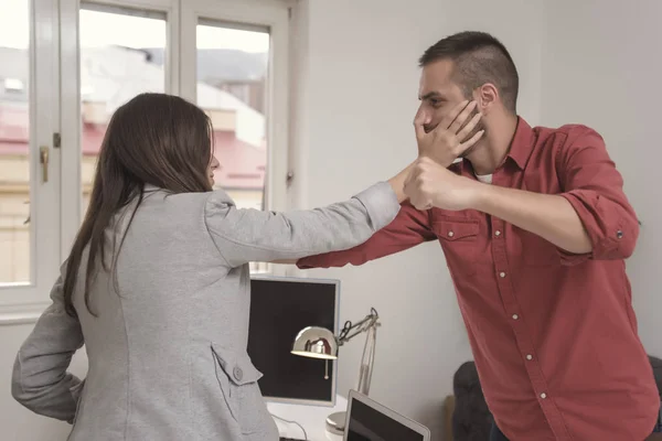 Businessman going to punch hitting colleague in the face during meeting