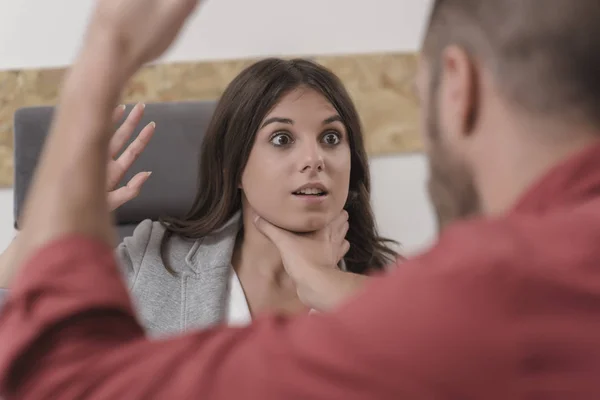 Businessman going to punch hitting colleague in the face during meeting