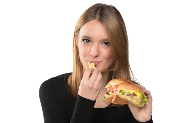 Portréja Egy Szép Fiatal Lány Eszik Egy Hamburgert Fehér Háttér — Stock Fotó