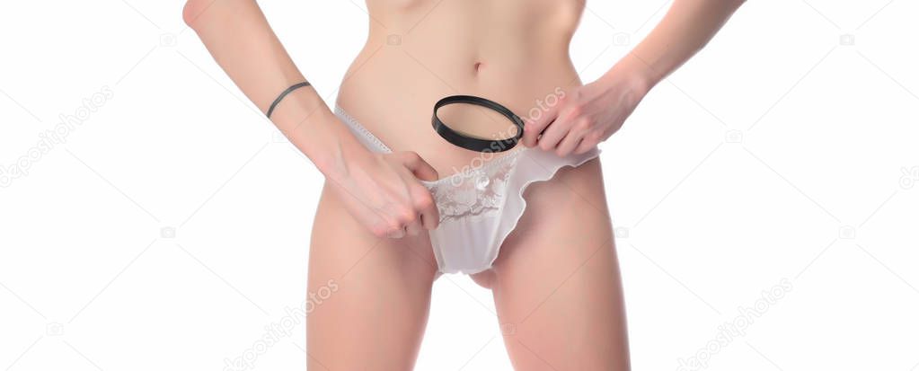 Woman looking with a magnifying glass in her panties