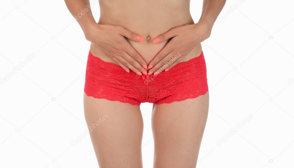 pretty woman in panties showing pain in her abdomen. Isolated on white background