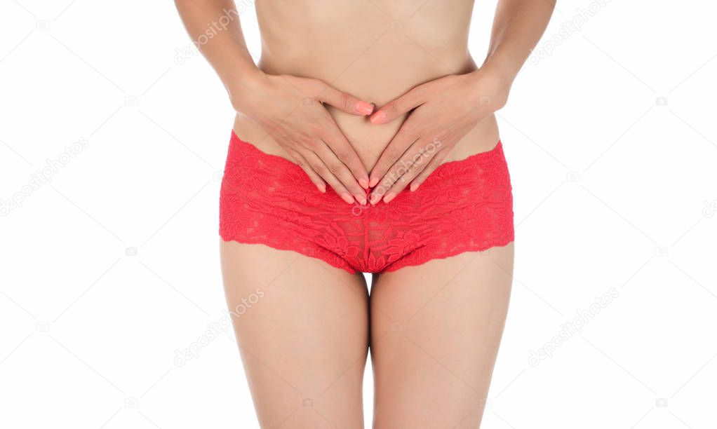 pretty woman in panties showing pain in her abdomen. Isolated on white background