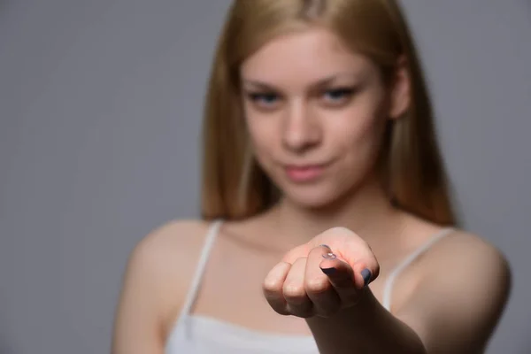 Contact Lens For Vision. Young woman holding a contact lens on a finger