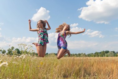 Happy twins jumping