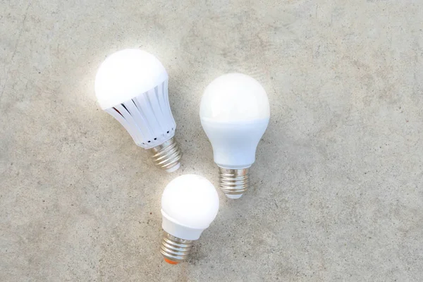 LED Bulbs with lighting on the concrete floor — Stock Photo, Image