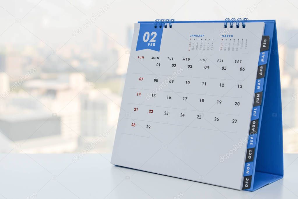 Close up - Calendar of February on the white table with city view background