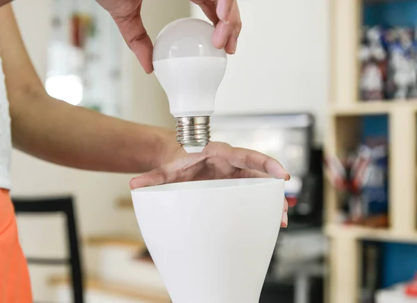 Changing bulb to LED to use with lamp — Stock Photo, Image