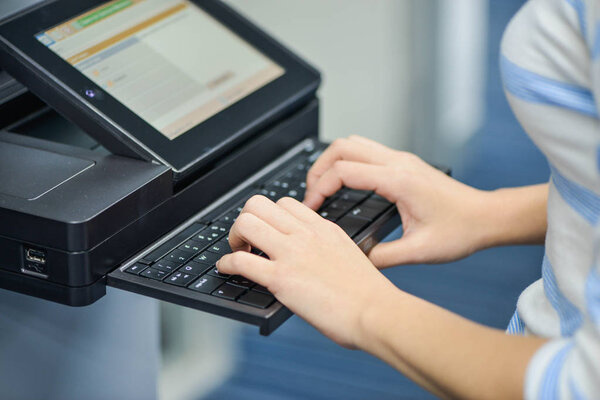 Business woman is using the printer to scanning and printing