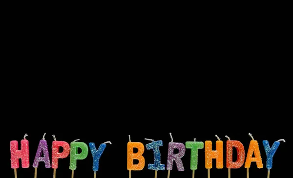 Colorato di felice candela di compleanno sul nero — Foto Stock