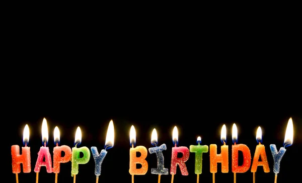 Colorful of happy birthday candle with flame lighting on the black