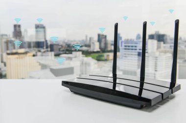 Black three poles wifi router on the white table clipart