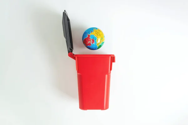 Red trash with globes on the white screen for save the earth concept