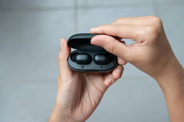 Close up of woman is open the black true wireless earbuds case