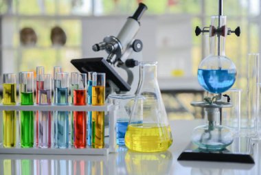 Kucağında kimyasal bileşikler olan cam laboratuarı kimyasalı kapat.