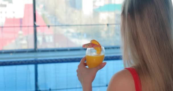 Long haired lady enjoys delicious orange beverage closeup — Stock Video