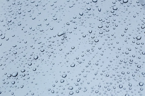Rain drops on a car hood silver rainy season — Stock Photo, Image