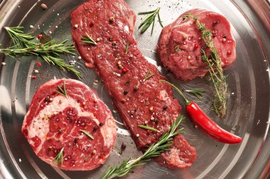 Fresh raw Prime Black Angus beef steaks on steel background clipart